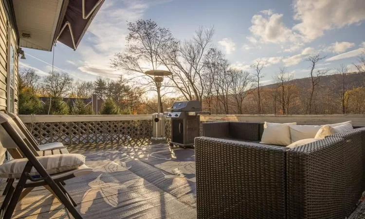 Deck at dusk featuring grilling area