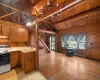 Kitchen featuring sink, lofted ceiling with beams, wooden ceiling, and electric stove