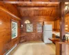 Kitchen featuring wooden ceiling, a baseboard radiator, vaulted ceiling with beams, pendant lighting, and white appliances