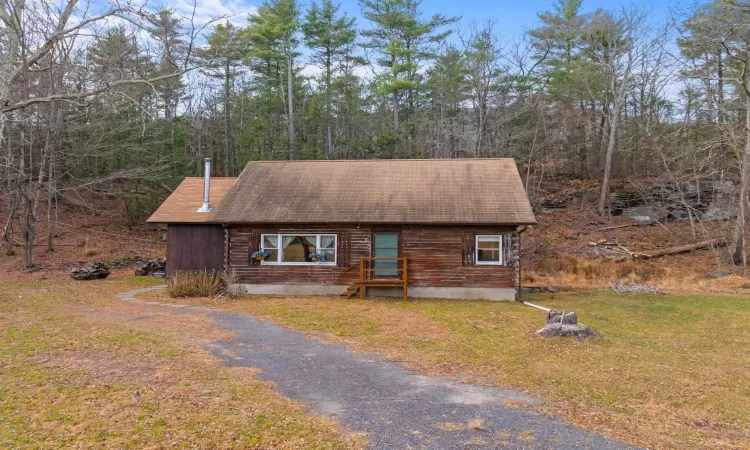 Log cabin with a front yard