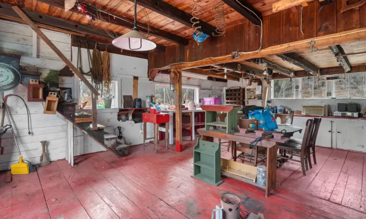 Miscellaneous room featuring beam ceiling, hardwood / wood-style flooring, and plenty of natural light