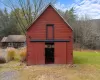 View of outbuilding featuring a lawn