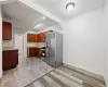 kitchen w/ stainless steel appliances and floor tiles, 1st floor unit