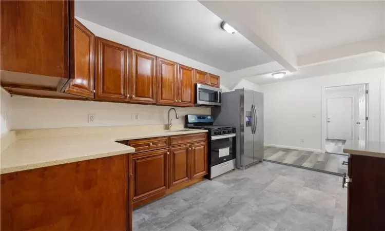 kitchen w/ wood cabinets, new stainless steel appliances, 1st floor unit