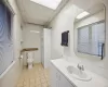 Bathroom featuring tile patterned flooring, a drop ceiling, tile walls, and toilet