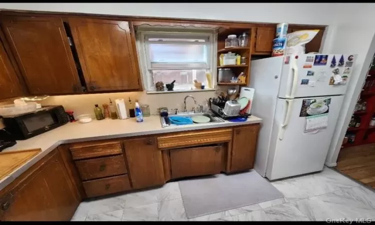 Kitchen featuring sink and white fridge