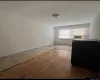 Empty room featuring light wood-type flooring and a baseboard radiator