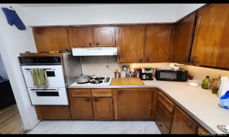 Kitchen featuring white appliances