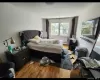 Bedroom with baseboard heating and light hardwood / wood-style flooring