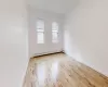 Spare room with light hardwood / wood-style floors and a baseboard heating unit