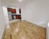 Kitchen with stainless steel appliances, a baseboard radiator, and light wood-type flooring