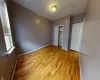 Unfurnished bedroom featuring a closet, baseboard heating, and light hardwood / wood-style flooring