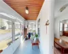 Sunroom / solarium with radiator heating unit and wooden ceiling