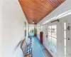 Sunroom with wooden ceiling, a healthy amount of sunlight, and lofted ceiling