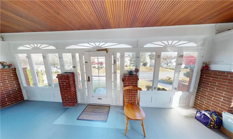 Sunroom with a wealth of natural light and wood ceiling