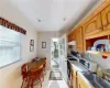 Kitchen with gas range gas stove, sink, light tile patterned floors, and plenty of natural light