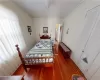 Bedroom with wood-type flooring and crown molding