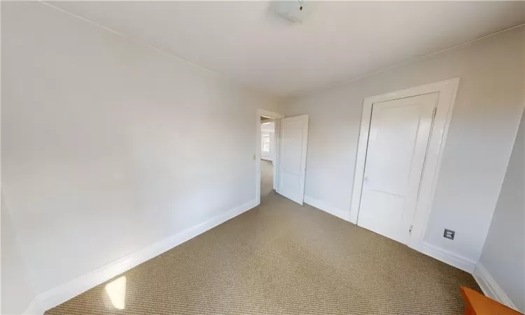 Unfurnished bedroom featuring carpet flooring and ornamental molding