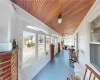 Sunroom featuring a wealth of natural light and wooden ceiling