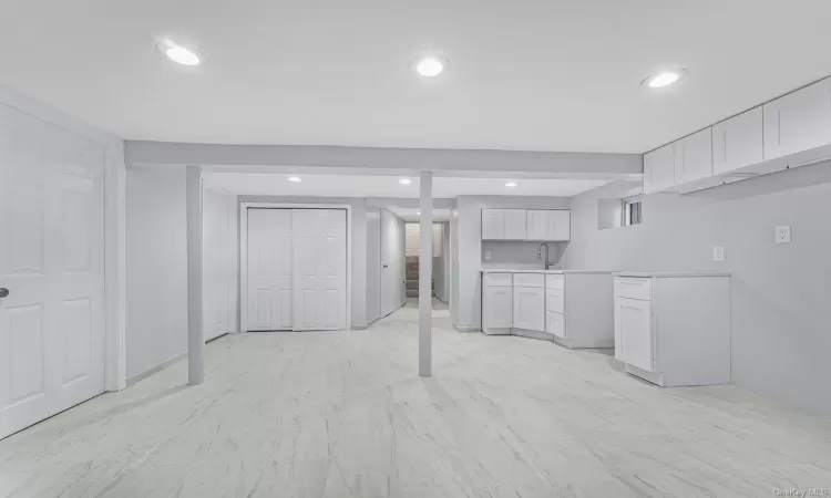 Kitchen featuring white cabinets and sink