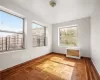 Empty room with radiator and light parquet flooring