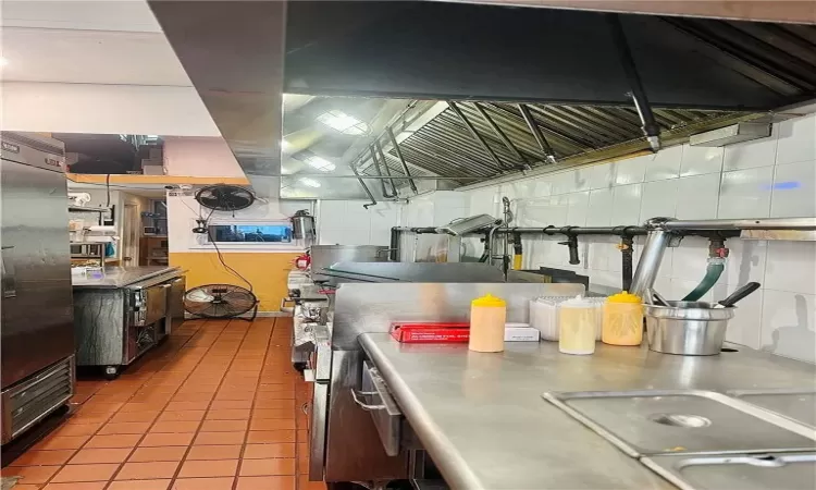 Kitchen with sink, stainless steel refrigerator, and tile patterned flooring