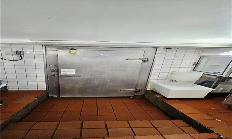 Bathroom with tile walls and tile patterned floors