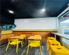 Recreation room featuring dark wood-type flooring, wood walls, and ornamental molding