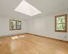 Primary Bedroom with a large skylight