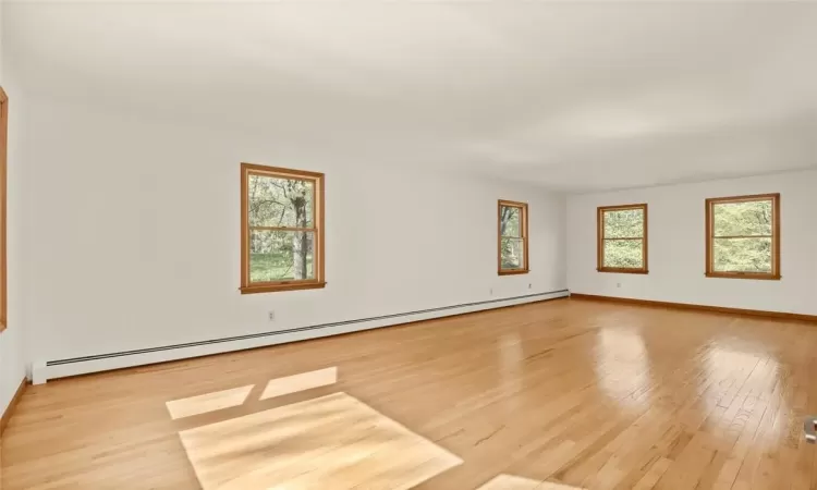 Living Room with lots of natural lighting, hardwood flooring.