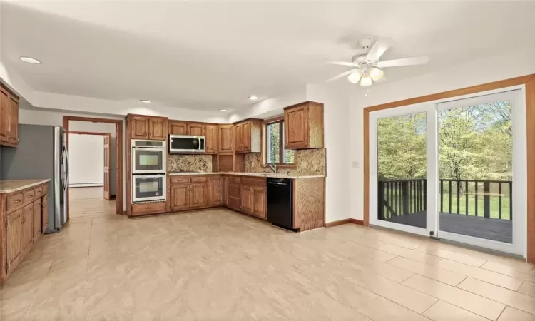 Renovated Kitchen with New Stainless Steel appliances and granite countertops.  Breakfast area with Glass doors out to deck.