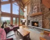 Living room featuring hardwood / wood-style flooring, a fireplace, and high vaulted ceiling