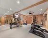 Workout area featuring wooden walls and ceiling fan