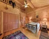 Bedroom with beamed ceiling, light wood-type flooring, and wooden ceiling