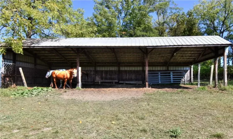 View of outbuilding featuring a lawn