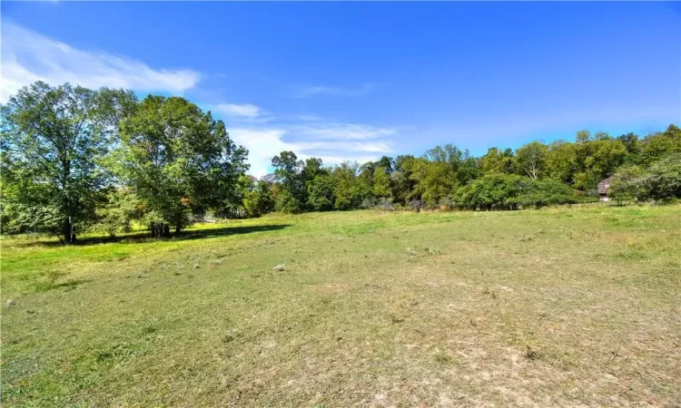 View of yard with a rural view