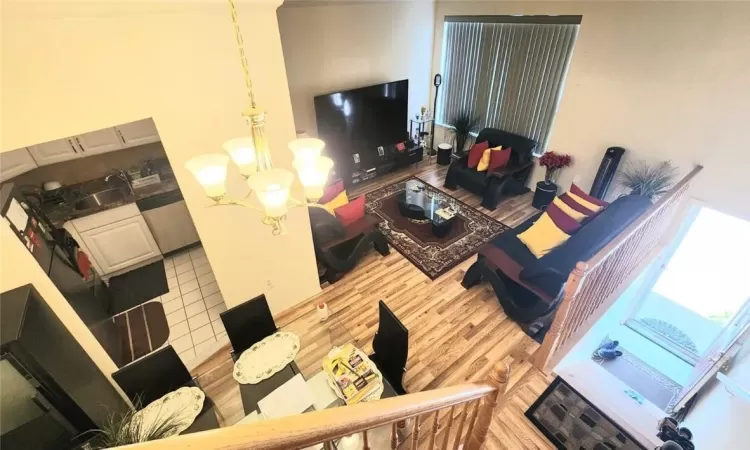 Living room with a notable chandelier, hardwood / wood-style flooring, and sink