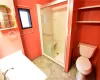 Bathroom with a shower with shower door and toilet