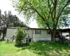 Rear view of house with a lawn