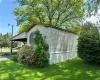 View of property exterior featuring a lawn