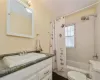 Full bathroom featuring tile flooring, shower / tub combo, vanity, and toilet