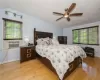 Bedroom featuring lofted ceiling, ceiling fan, and light hardwood / wood-style flooring