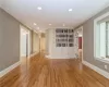 Unfurnished living room featuring light hardwood / wood-style flooring and crown molding