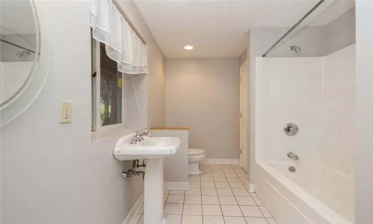 Bathroom featuring tile flooring, shower / washtub combination, and toilet, Bacement