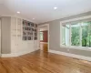 Empty room with a wealth of natural light, ornamental molding, and light hardwood / wood-style flooring