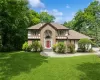 Tudor home with a front yard