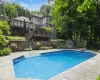 View of pool with a diving board and a deck