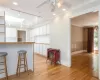 Kitchen with white cabinets, ceiling fan, light hardwood / wood-style flooring, and rail lighting