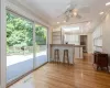 Kitchen featuring light hardwood / wood-style floors, kitchen peninsula, white cabinets, and a breakfast bar area