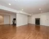 Unfurnished living room with hardwood / wood-style flooring and a wood stove